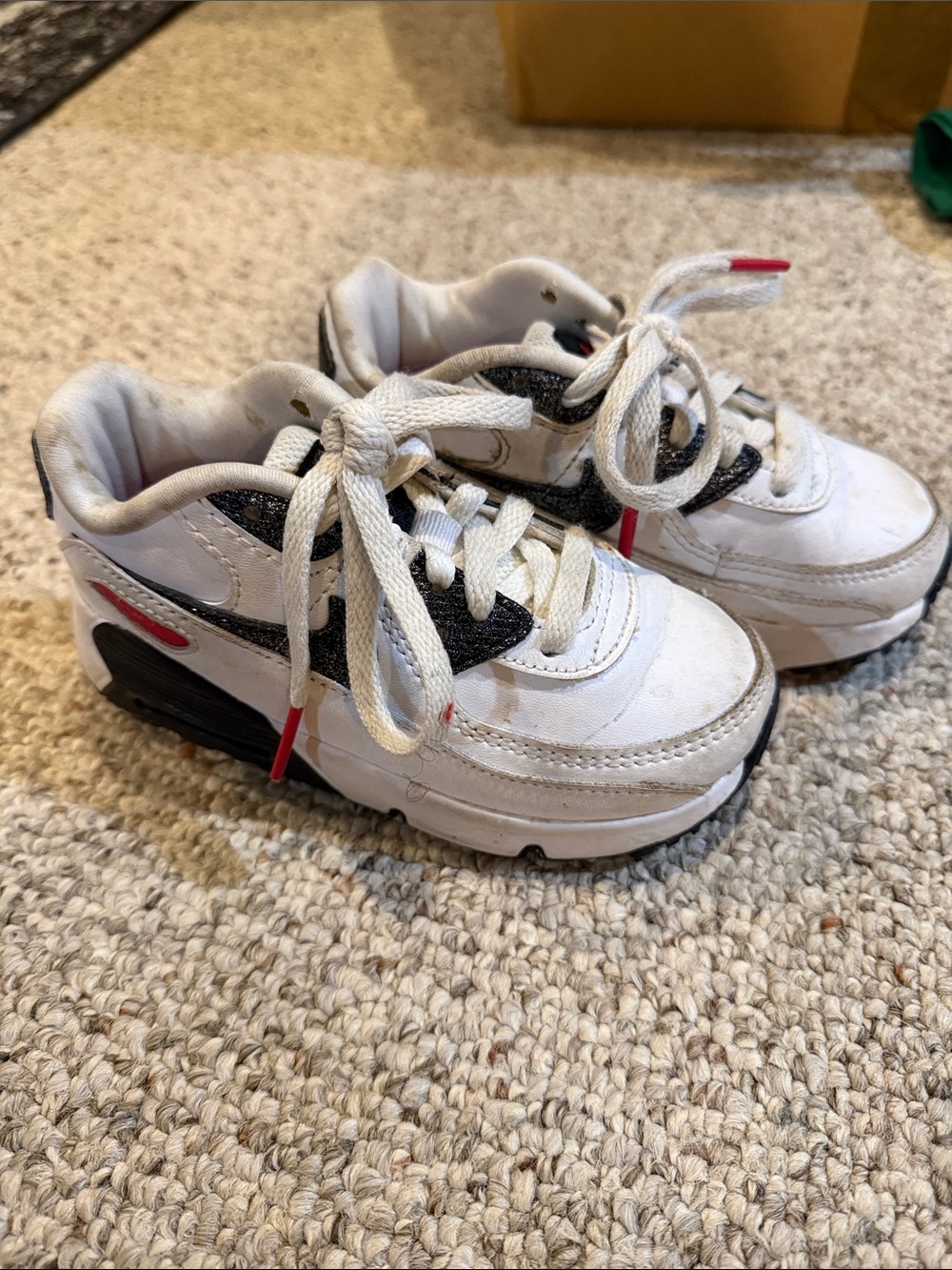 Nike Kids White Sneakers with Black Swoosh and Red Accents